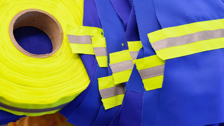 Reflective tape being added to clothing - reflective tape - reflective clothing