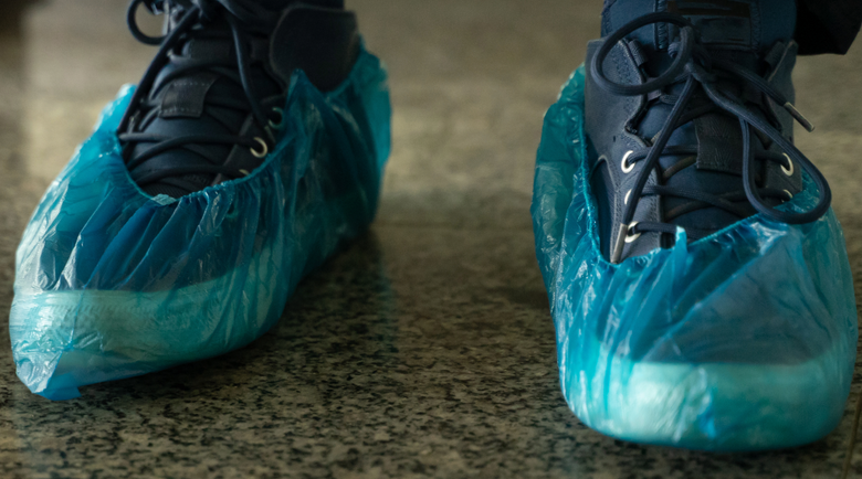 Sneakers with blue disposable shoe covers - disposable shoe covers - shoe covers