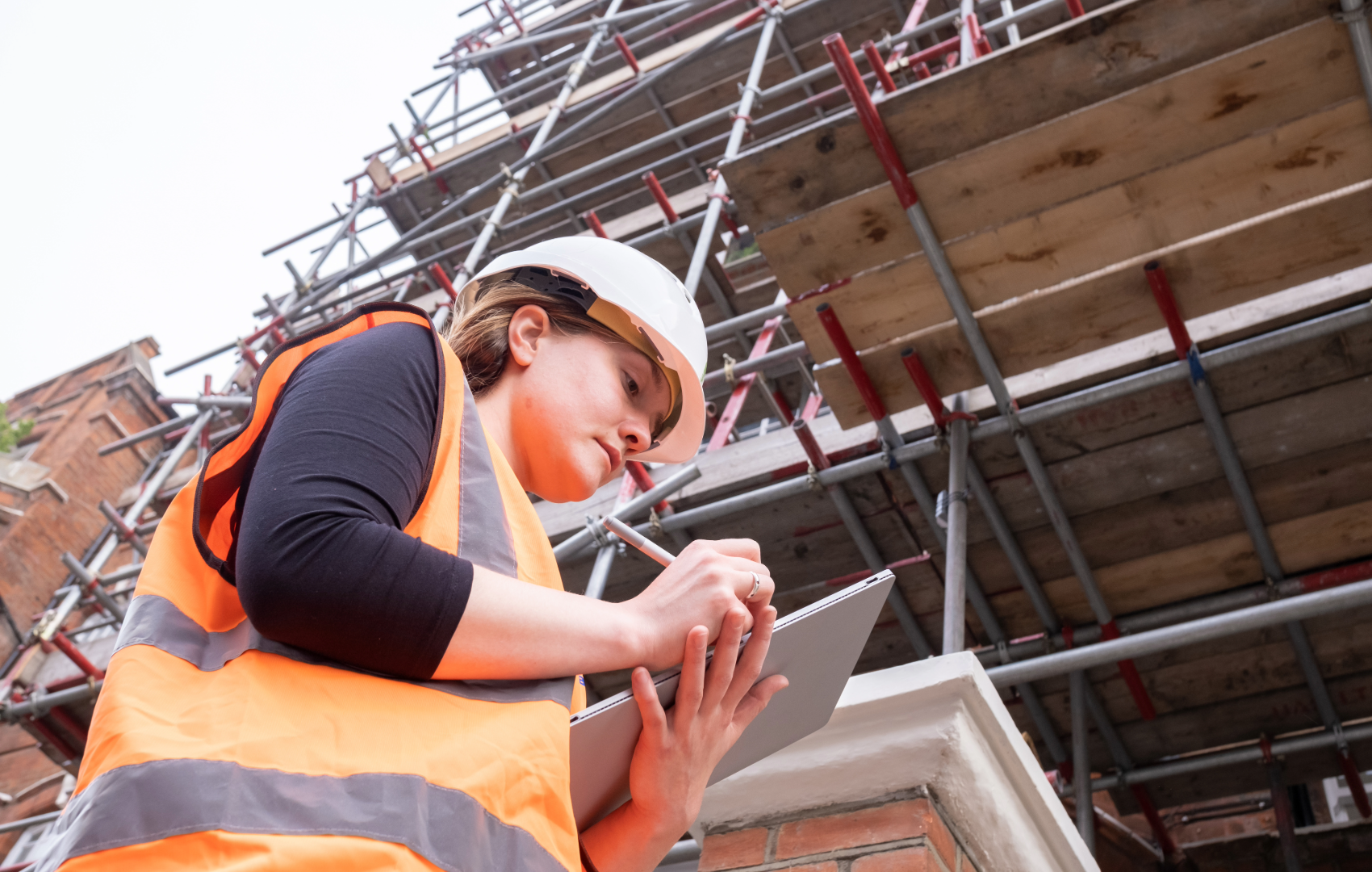 Woman wearing hard hat on construction site - hard hat - safety hat