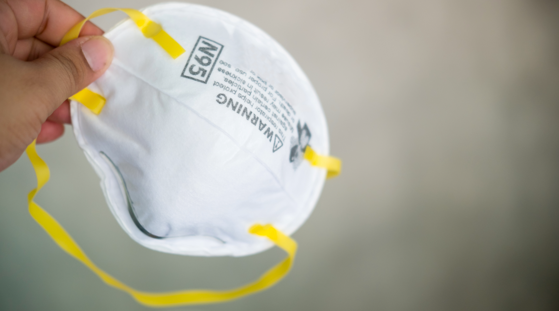 Dust mask being held up - dust mask - safety mask