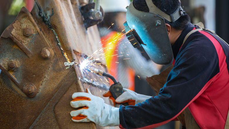 Employee welding  machine bucket - welding gloves - welding protective equipment