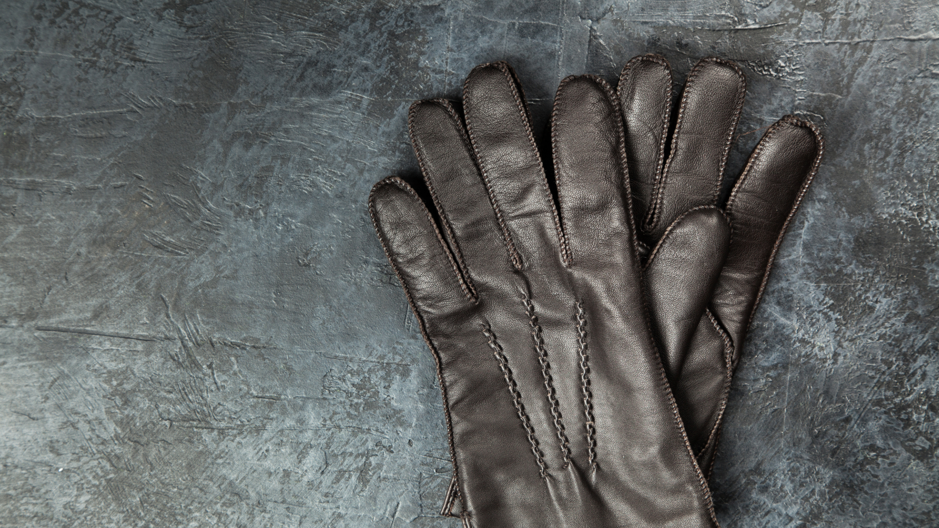 Leather gloves lying on workplace floor - leather gloves - hand gloves