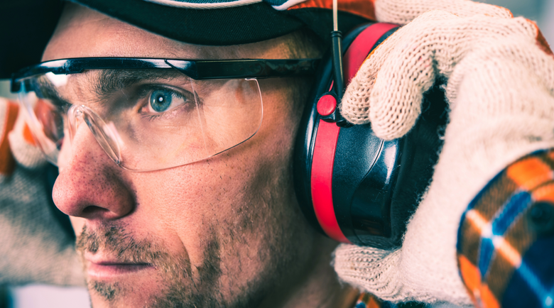 Man wearing safety glasses and earmuffs - safety glasses - lab safety glasses