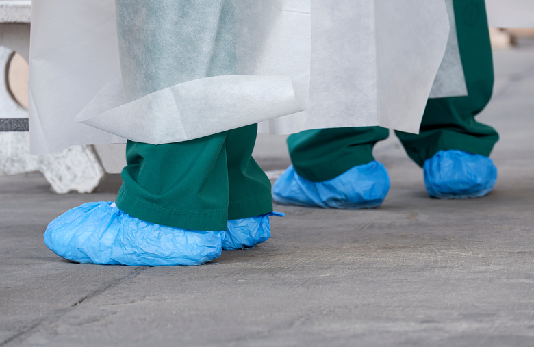 People in disposable shoe covers // disposable shoe covers, protective wear