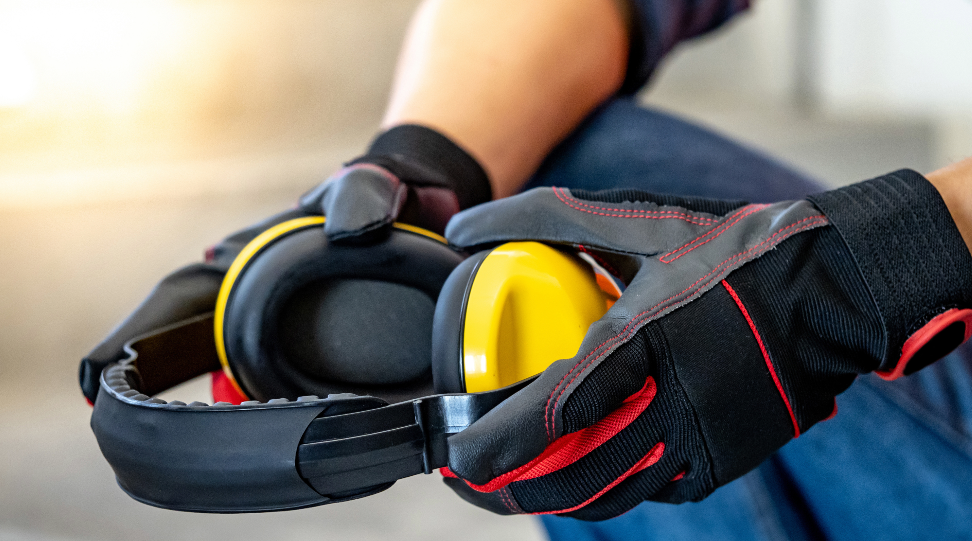 Someone holding earmuffs - ear muffs - hearing protection