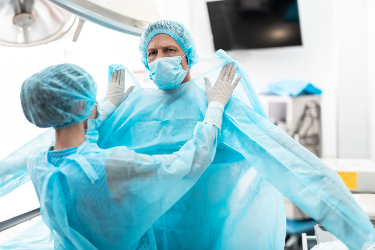 A  healthcare worker wearing a surgical coat 