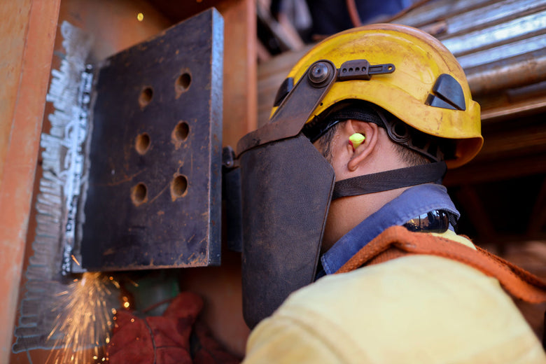 Man working wearing earplugs on